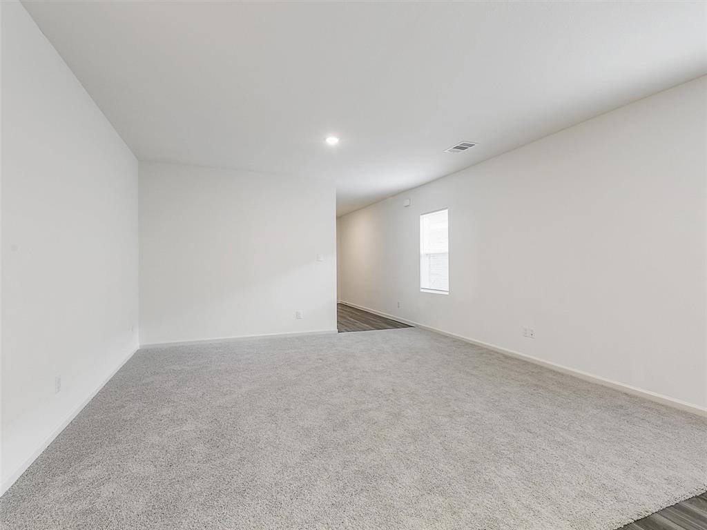 4510 Winecup Road Melissa, TX 75454 - Photo 7 of 22 Spacious room featuring light gray carpeting, neutral wall finishes, a recessed ceiling light, and a single window allowing ambient illumination