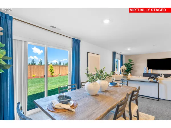 a living room with furniture kitchen view and a table
