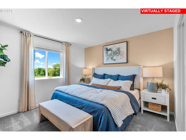 a bedroom with a bed and a painting on the wall