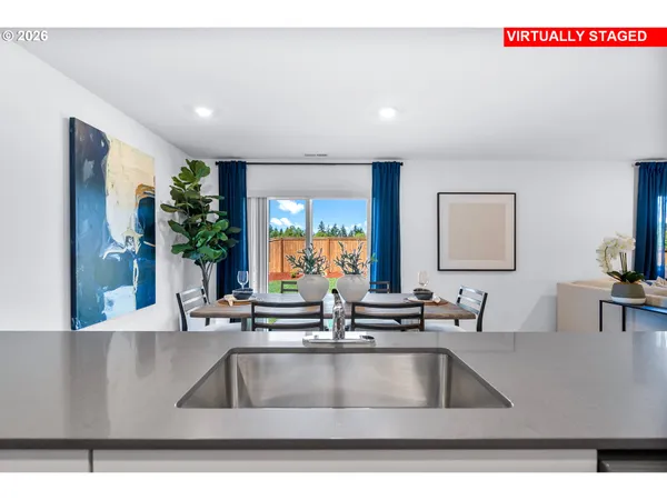 a kitchen with stainless steel appliances granite countertop a stove and white cabinets