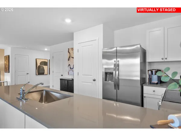 a kitchen with kitchen island a sink stainless steel appliances and refrigerator