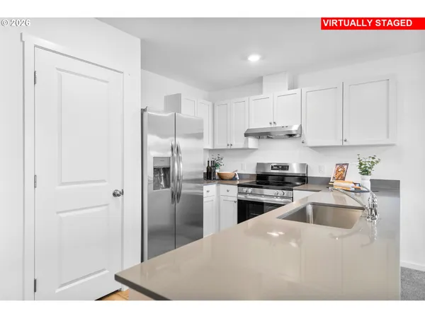 a kitchen with a table and chairs in it