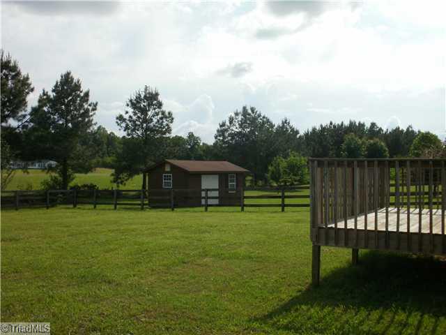 180 Farmview Road Madison, NC 27025 - Photo 3 of 16 Yard/Garden. Fenced back-yard with deck and wired workshop