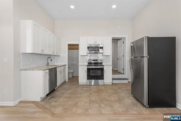 a kitchen with a refrigerator sink and stove