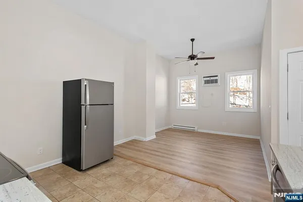 an empty room with windows and closet