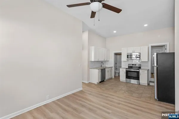 a kitchen with stainless steel appliances a refrigerator and a stove top oven