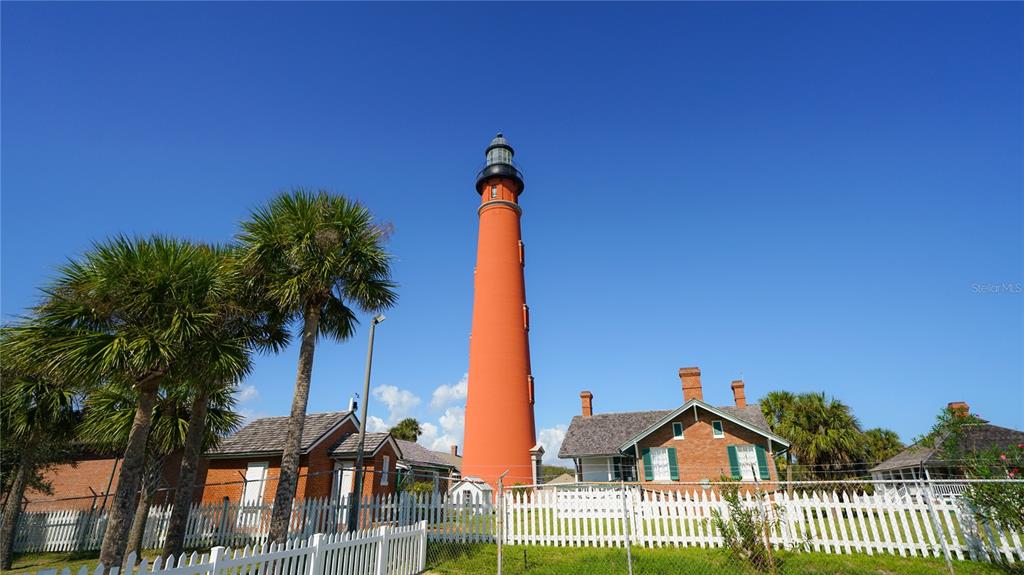 4738 South Atlantic Avenue Ponce Inlet, FL 32127 - Photo 30 of 32 a view of a house with a yard and potted plants