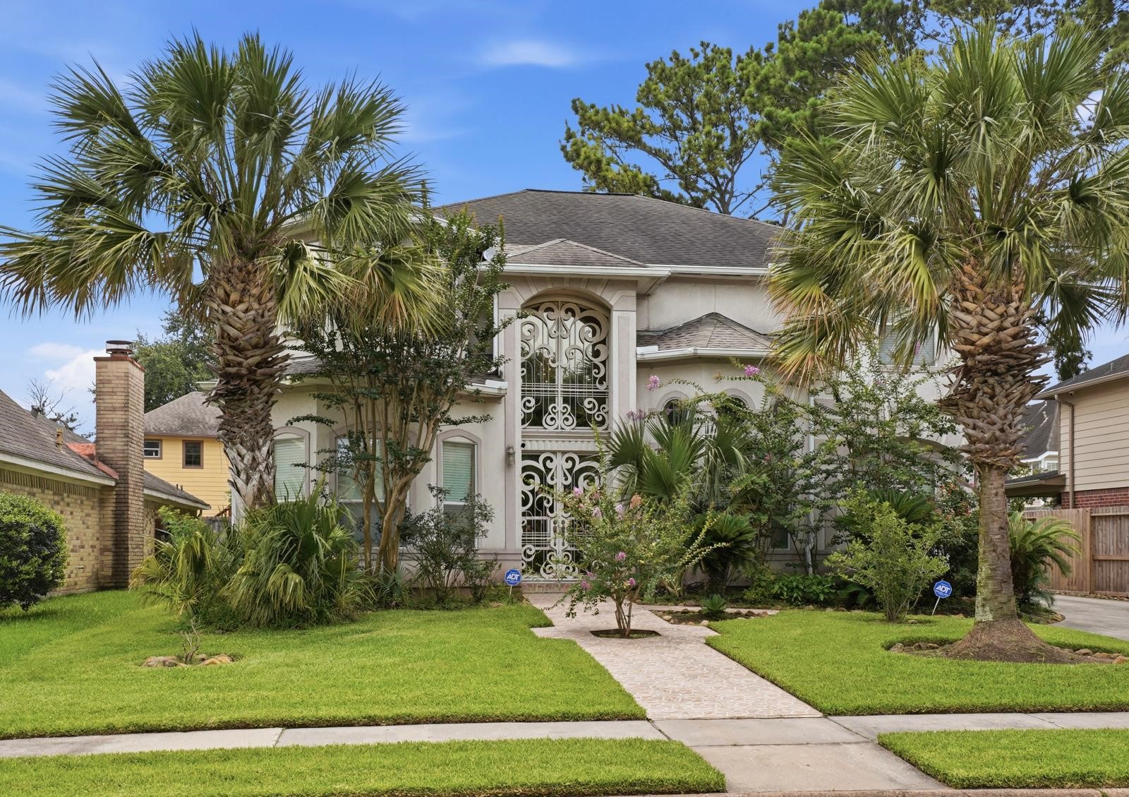 247 Old Spring Lane Houston, TX 77015 - Photo 2 of 25 a front view of a house with a garden