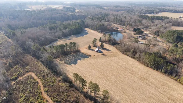 a view of a dry yard with wooden fence