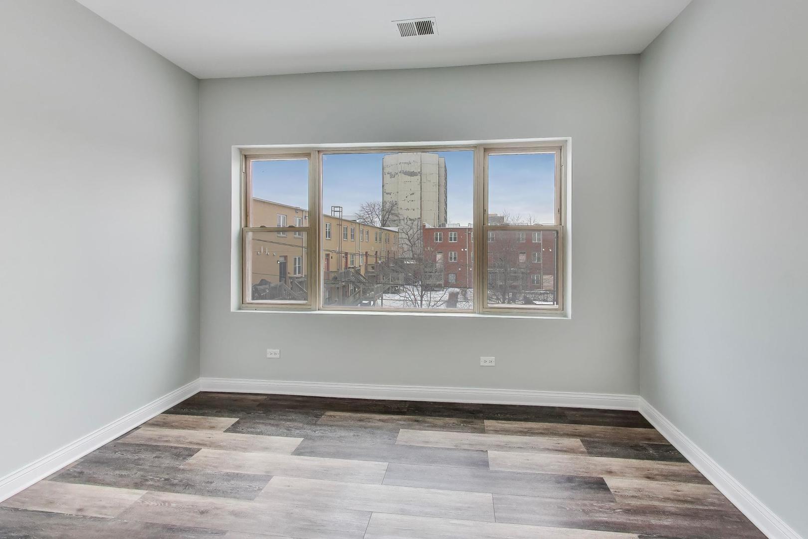 5938 South Indiana Avenue, Unit 2 Chicago, IL 60637 - Photo 12 of 17 a view of an empty room with wooden floor and a window