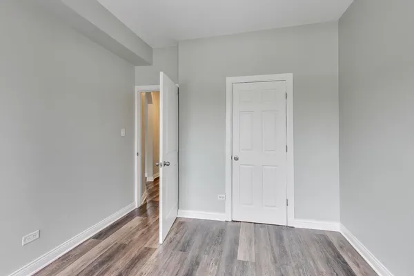 a view of an empty room and wooden floor