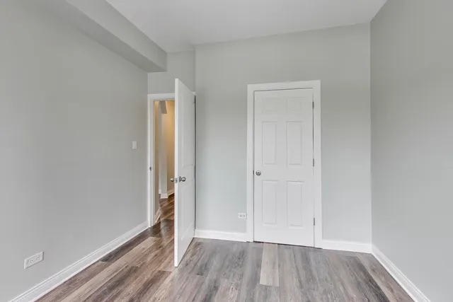 a view of an empty room and wooden floor