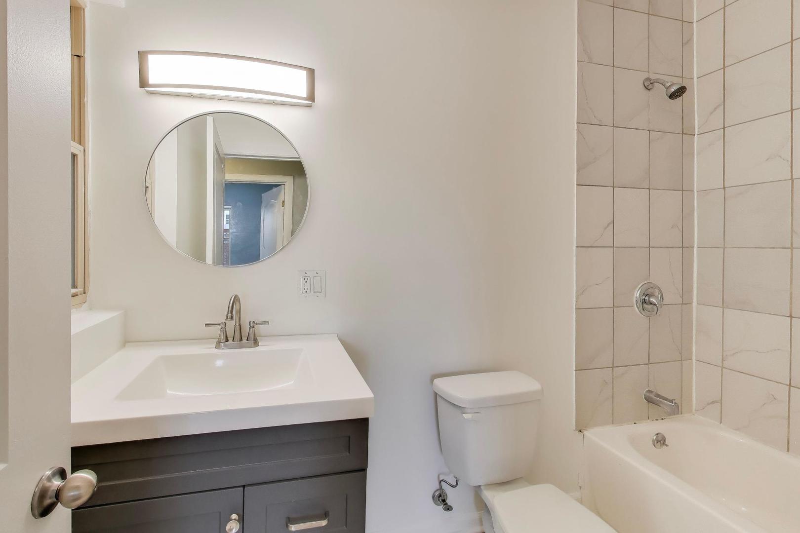 5938 South Indiana Avenue, Unit 2 Chicago, IL 60637 - Photo 16 of 17 a bathroom with a sink a toilet and shower