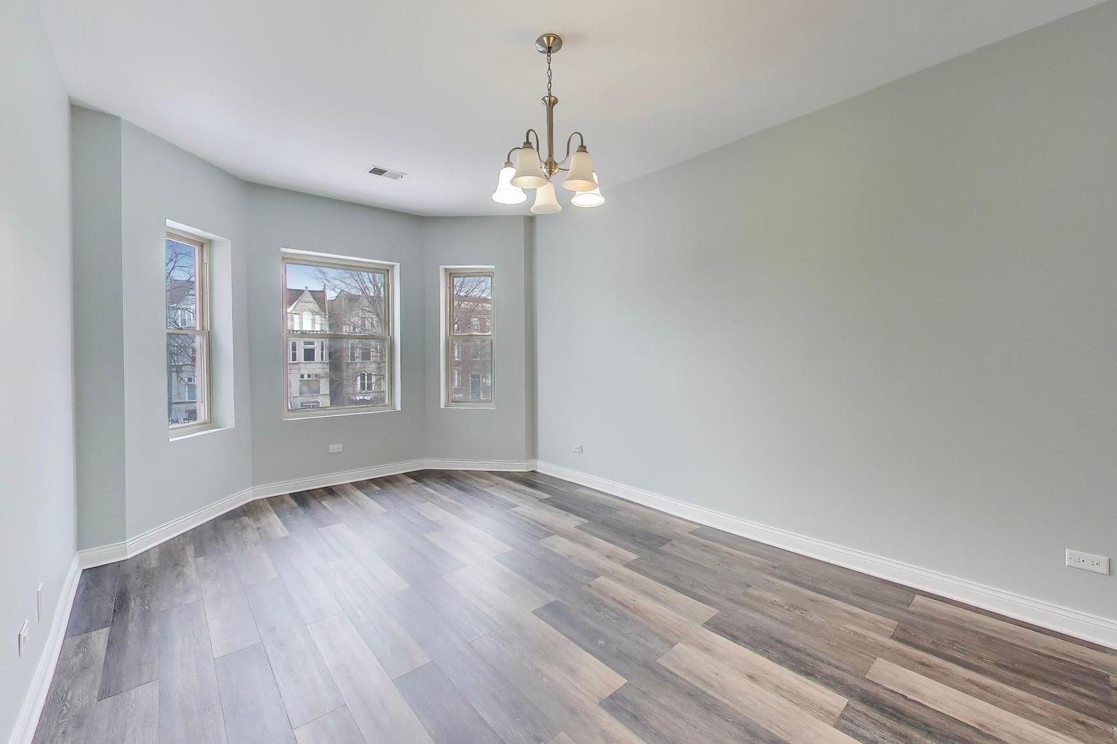 5938 South Indiana Avenue, Unit 2 Chicago, IL 60637 - Photo 2 of 17 wooden floor in an empty room with a window