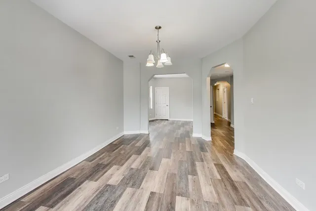 a view of a room with wooden floor closet and windows
