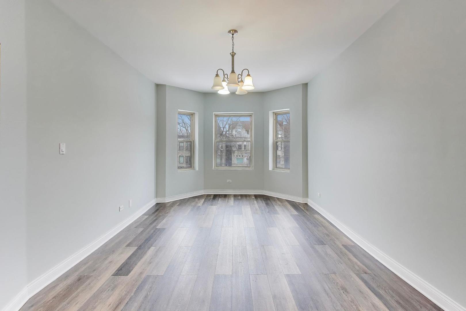 5938 South Indiana Avenue, Unit 2 Chicago, IL 60637 - Photo 4 of 17 wooden floor in an empty room with a window