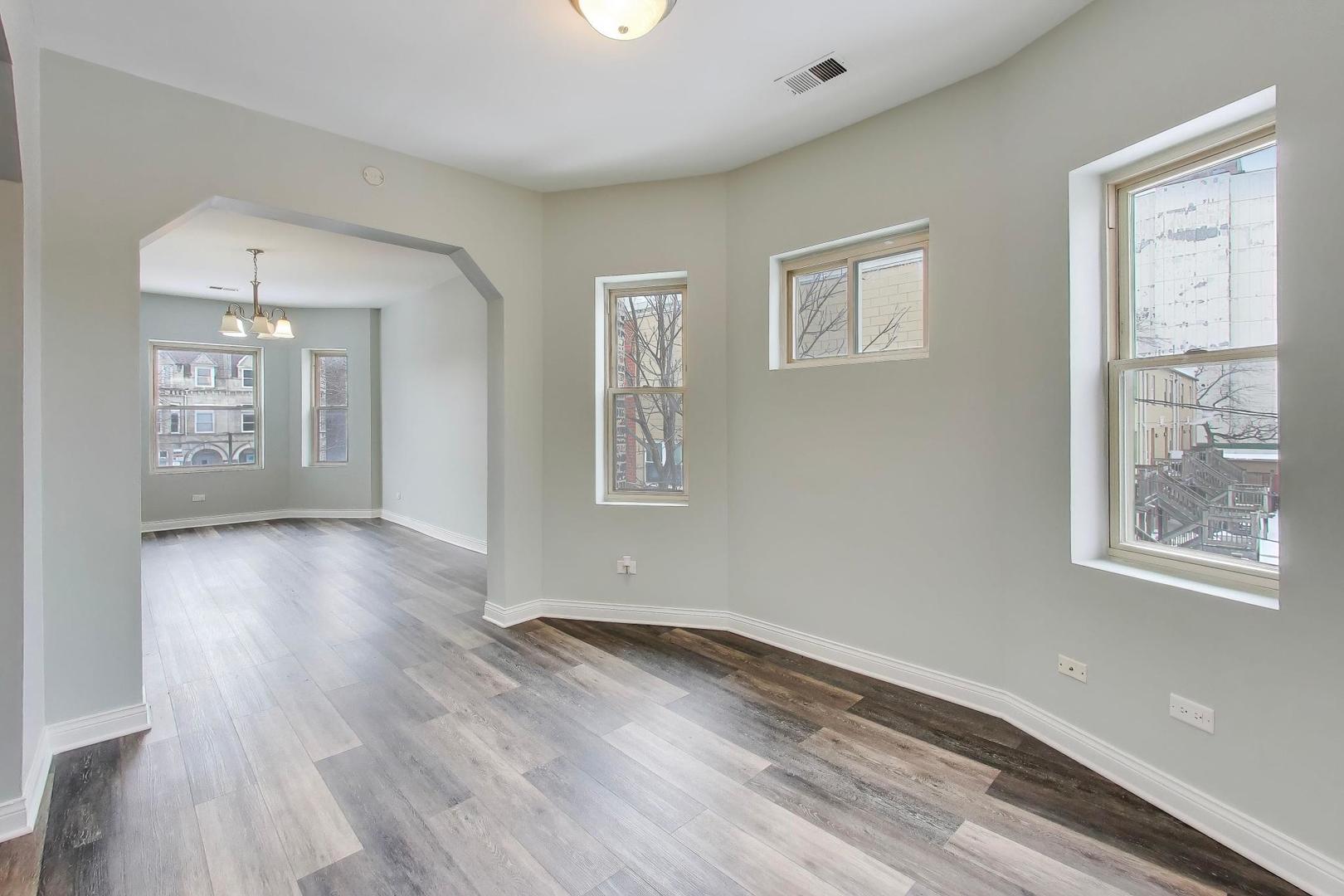 5938 South Indiana Avenue, Unit 2 Chicago, IL 60637 - Photo 5 of 17 a view of an empty room with wooden floor and a window