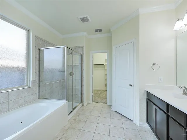 a bathroom with a bathtub shower and sink