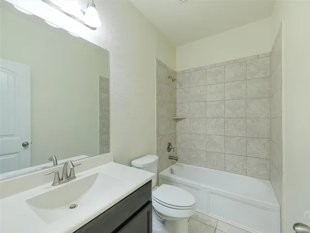 a bathroom with a sink a toilet and bathtub