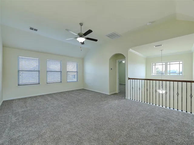 a view of n empty room with window and fireplace