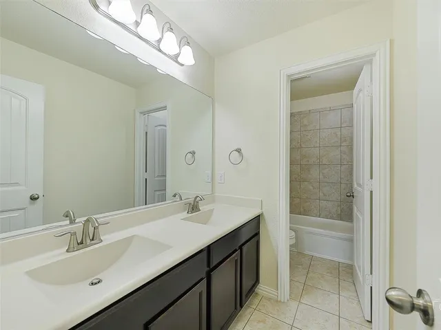 a bathroom with a sink double vanity and a mirror