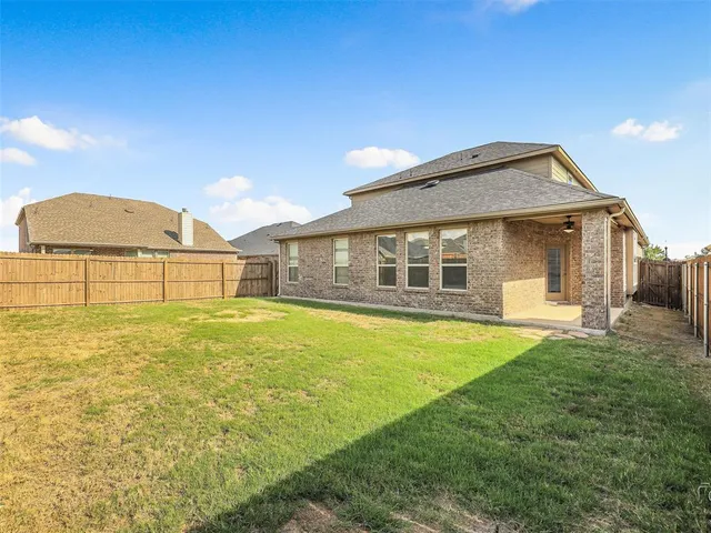a front view of a house with a big yard