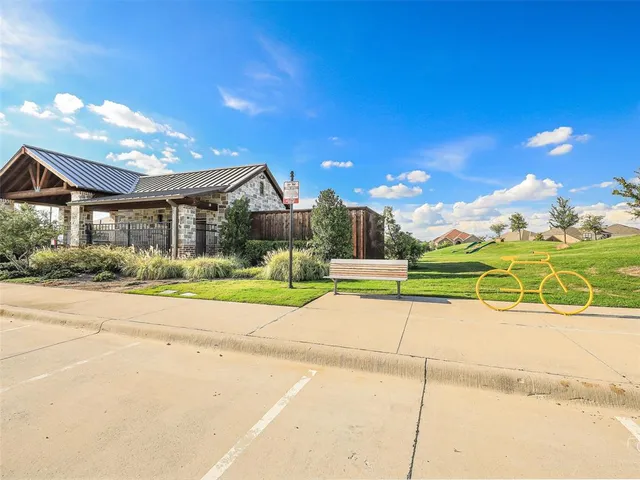 a view of a house with a big yard and potted plants