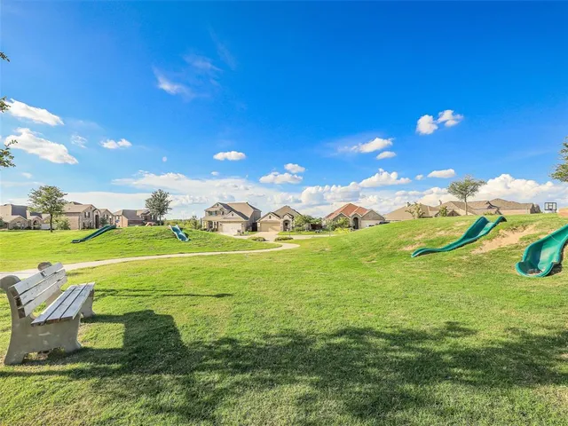 a view of an house with a backyard space and balcony