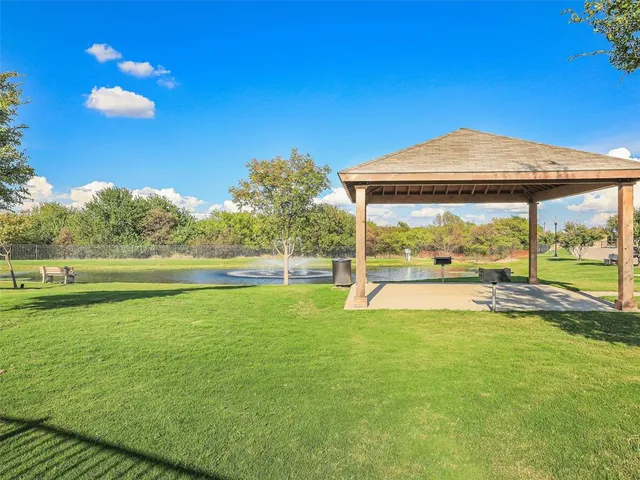a view of pool with a yard