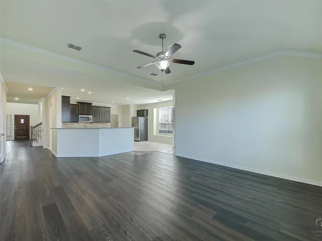 a view of a kitchen with wooden floor and a kitchen