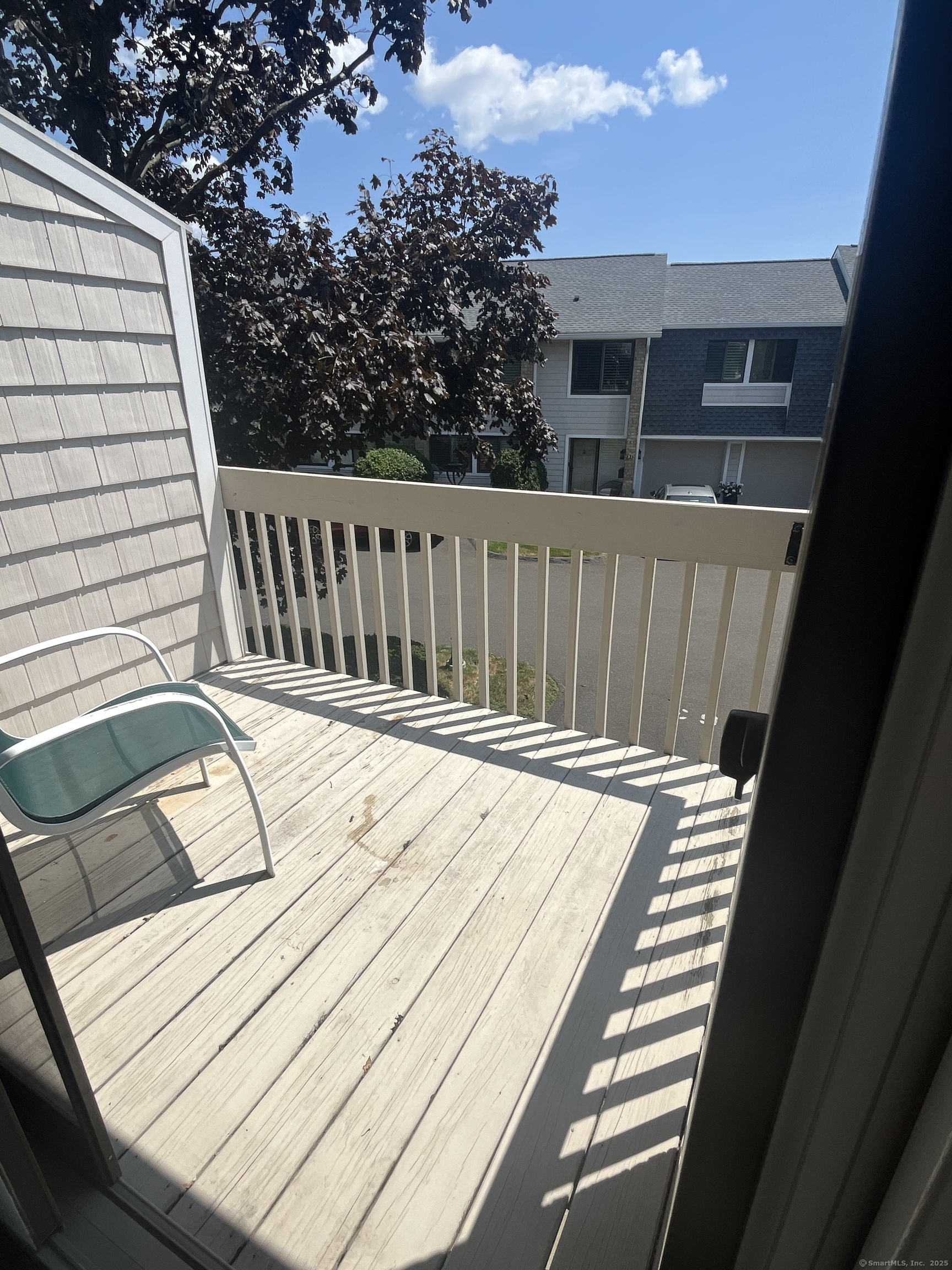199 Gregory Boulevard, Unit E4 Norwalk, CT 06855 - Photo 12 of 18 a view of a roof deck with wooden floor and fence
