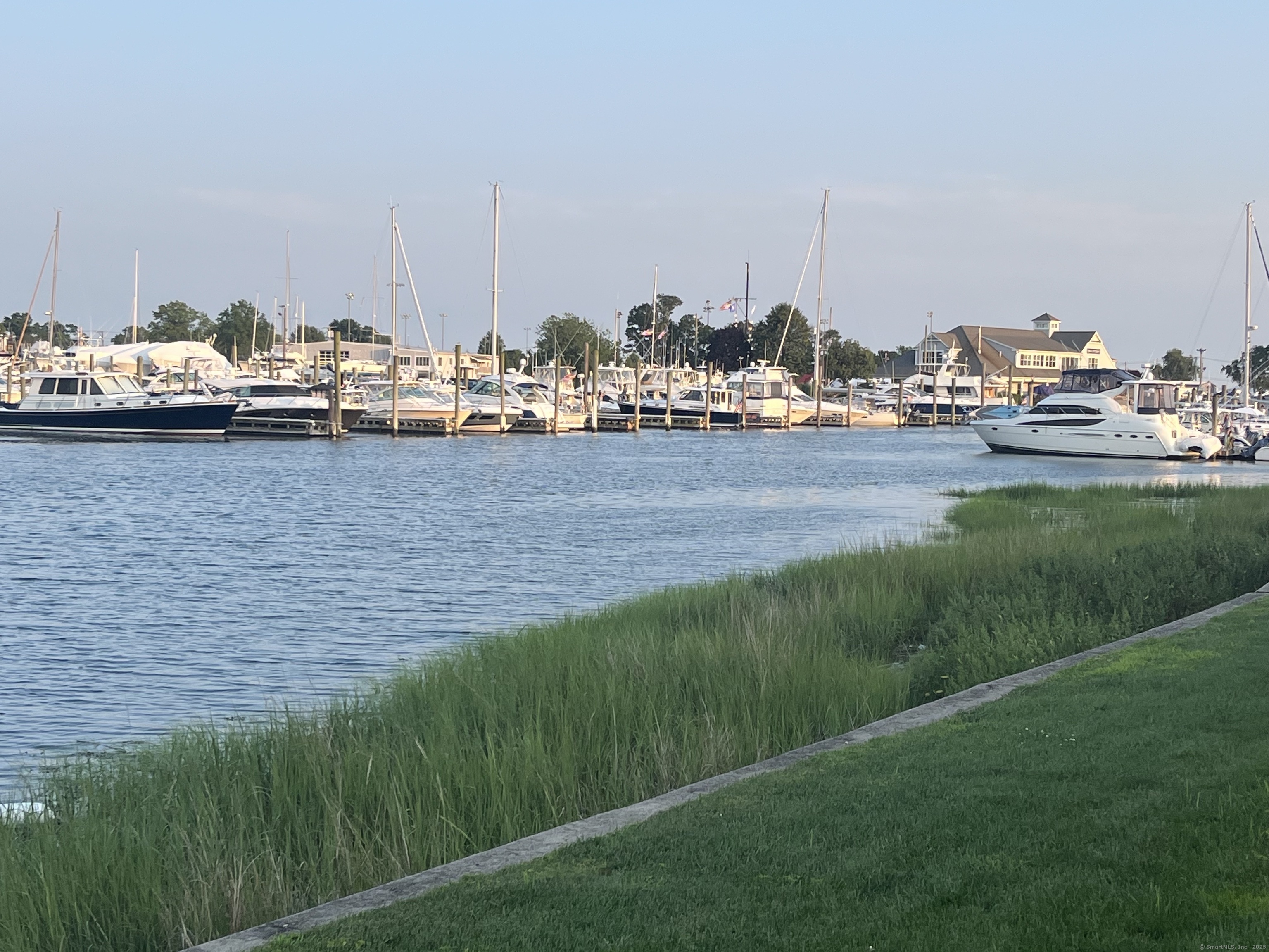 199 Gregory Boulevard, Unit E4 Norwalk, CT 06855 - Photo 15 of 18 a view of a lake with boats and trees in the background