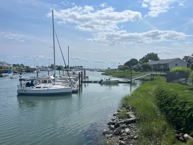 a view of a lake with boats next to a house
