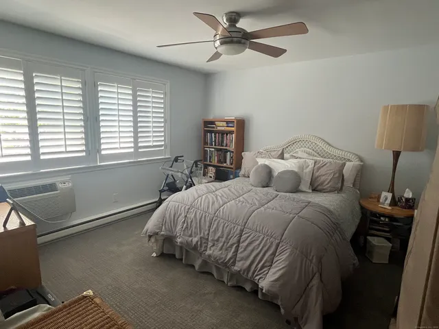 a bed sitting in a bedroom next to a window