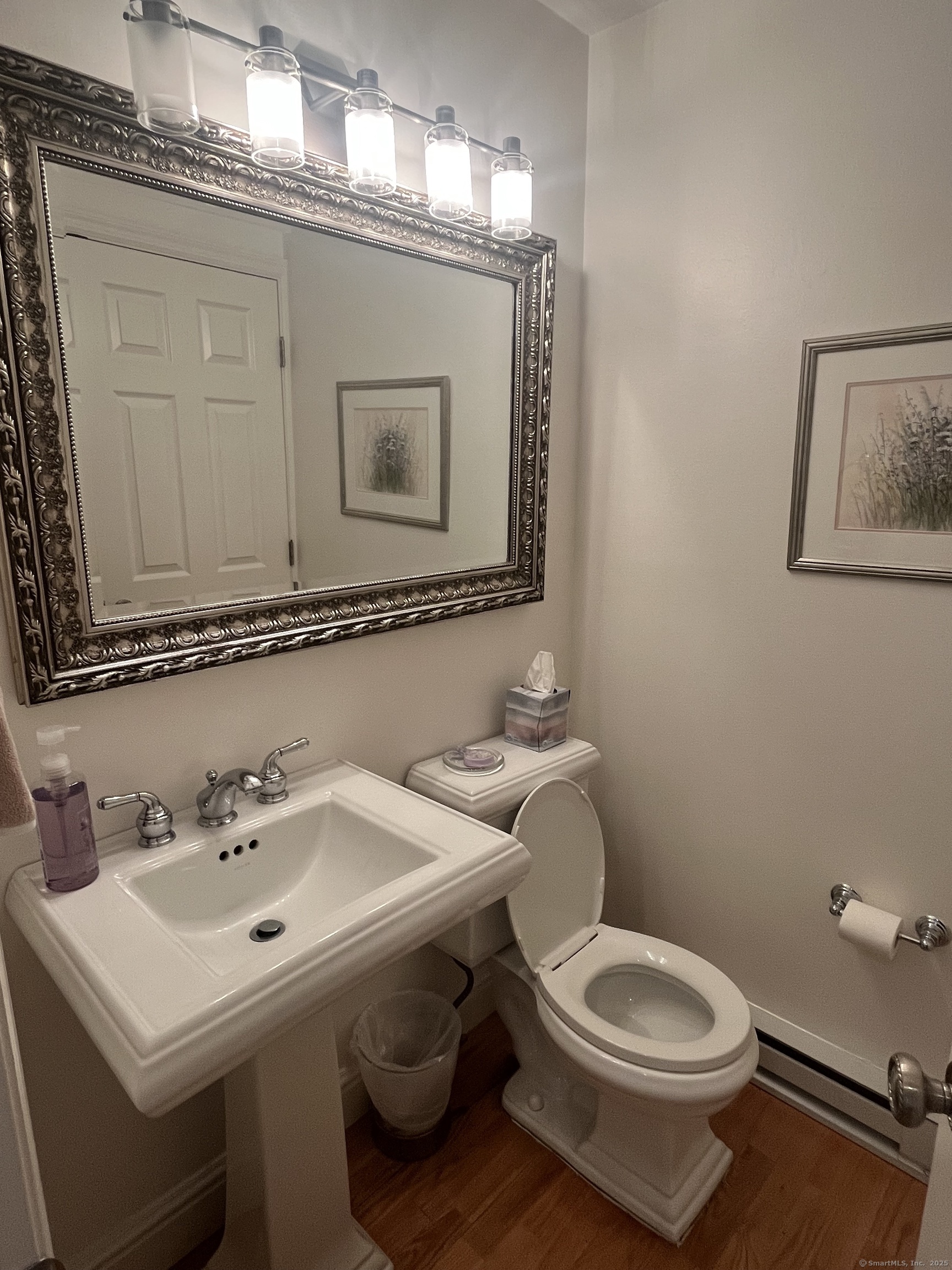 199 Gregory Boulevard, Unit E4 Norwalk, CT 06855 - Photo 7 of 18 a bathroom with a toilet a sink and mirror