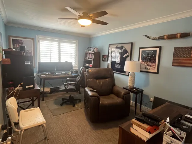 a livingroom with workspace couch and a window