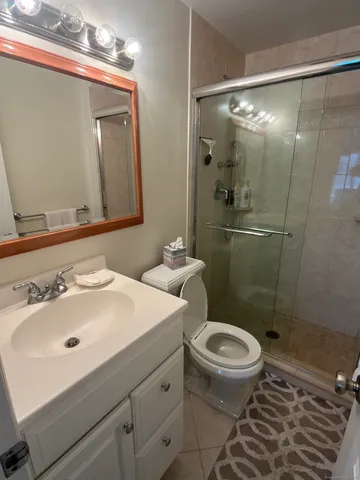 a bathroom with a sink toilet and shower
