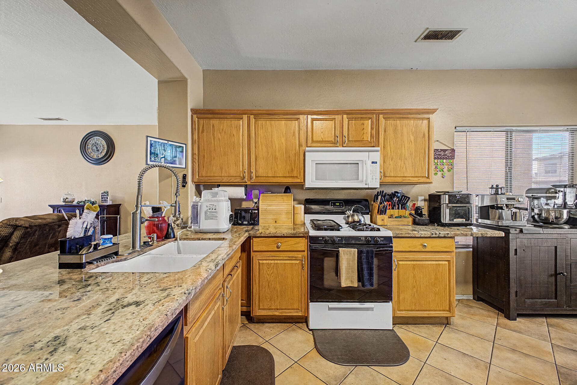 5301 West Grenadine Road Laveen, AZ 85339 - Photo 15 of 37 a kitchen with a stove a sink and a refrigerator