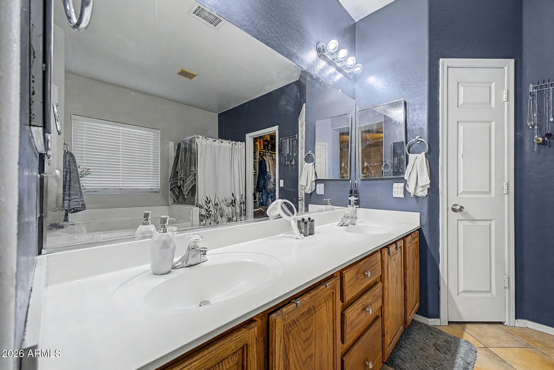 5301 West Grenadine Road Laveen, AZ 85339 - Photo 18 of 37 a bathroom with double vanity sink and a mirror
