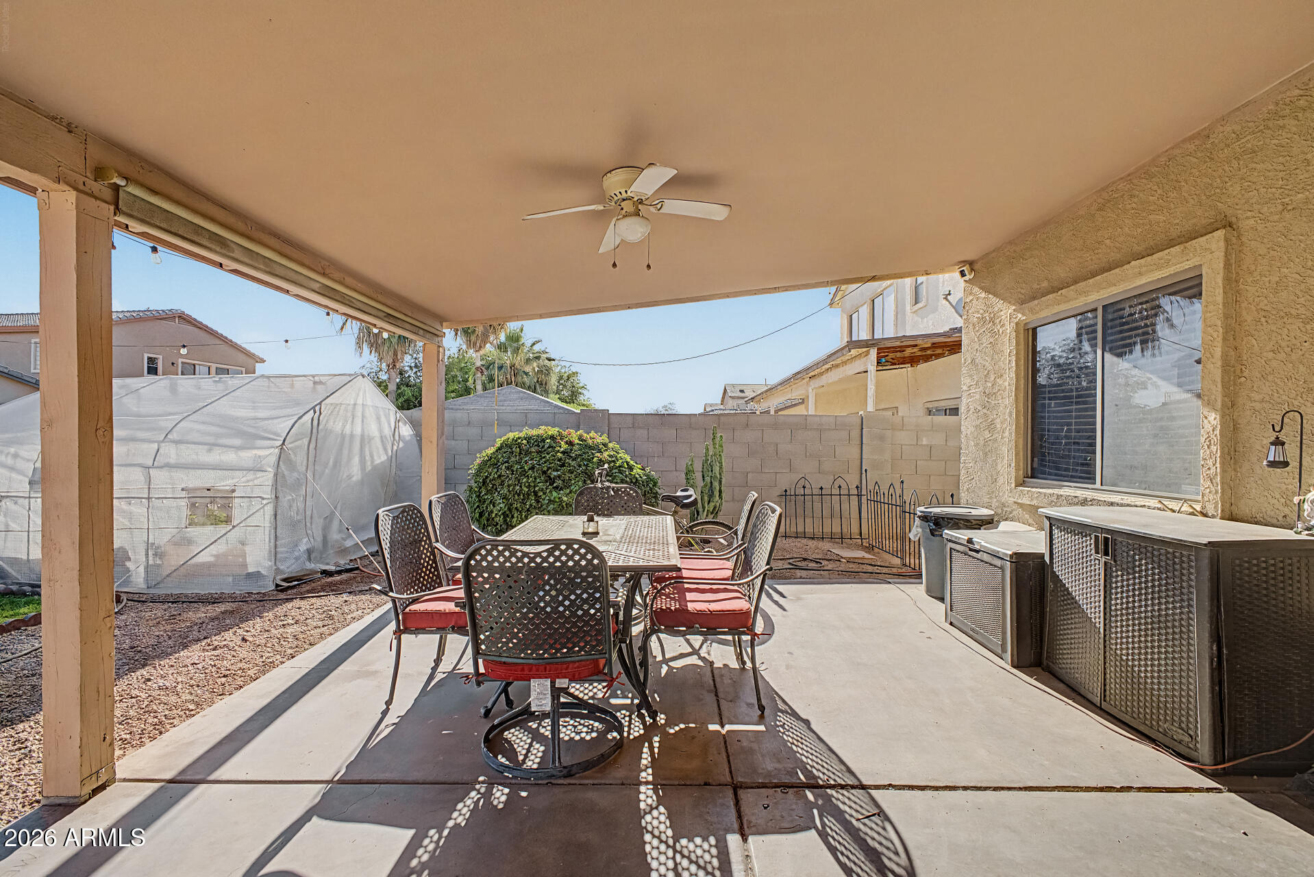 5301 West Grenadine Road Laveen, AZ 85339 - Photo 29 of 37 a dining room with furniture and a floor to ceiling window