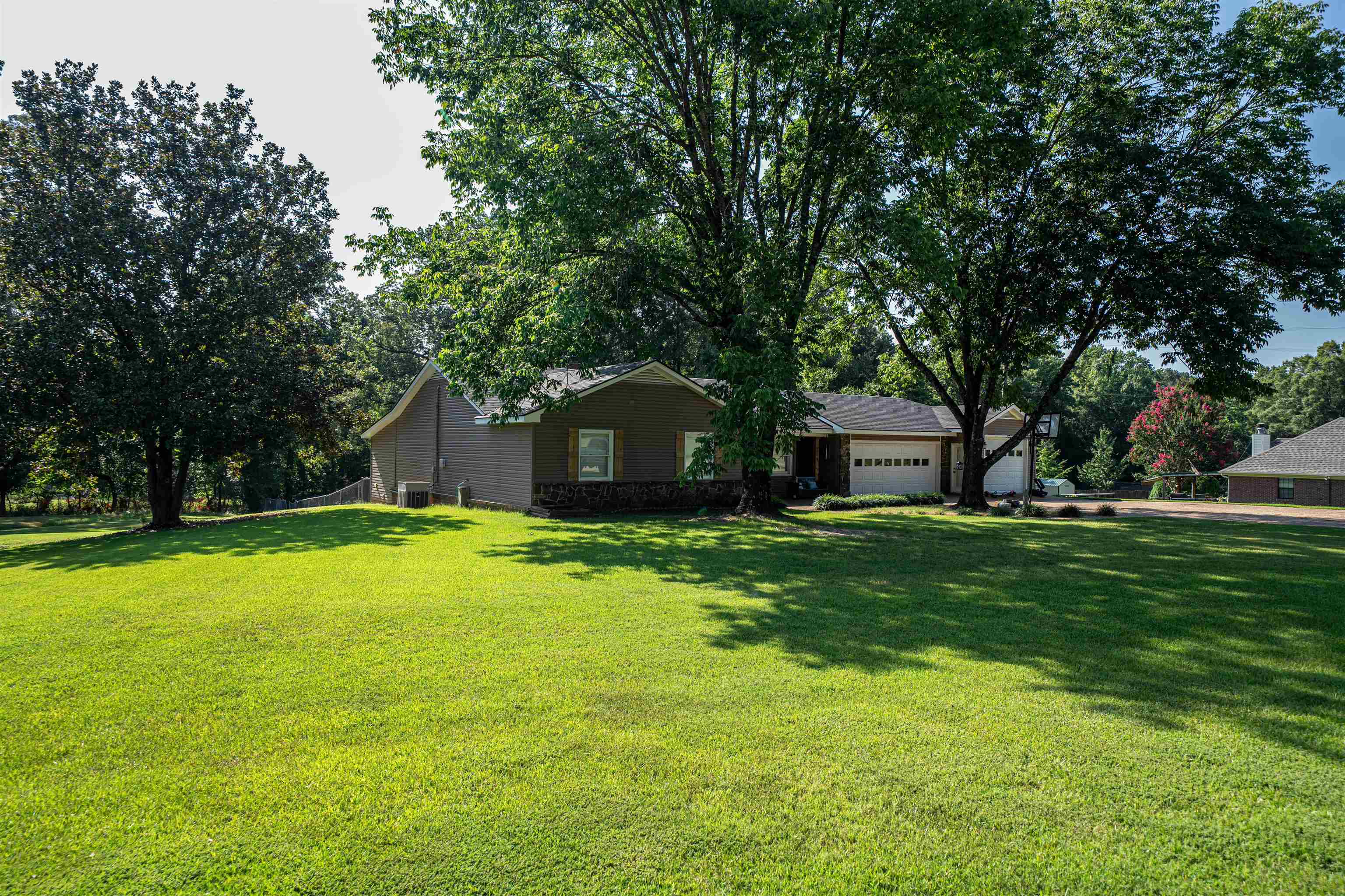 285 Woodbridge Road Somerville, TN 38068 - Photo 18 of 24 a front view of a house with a yard and trees