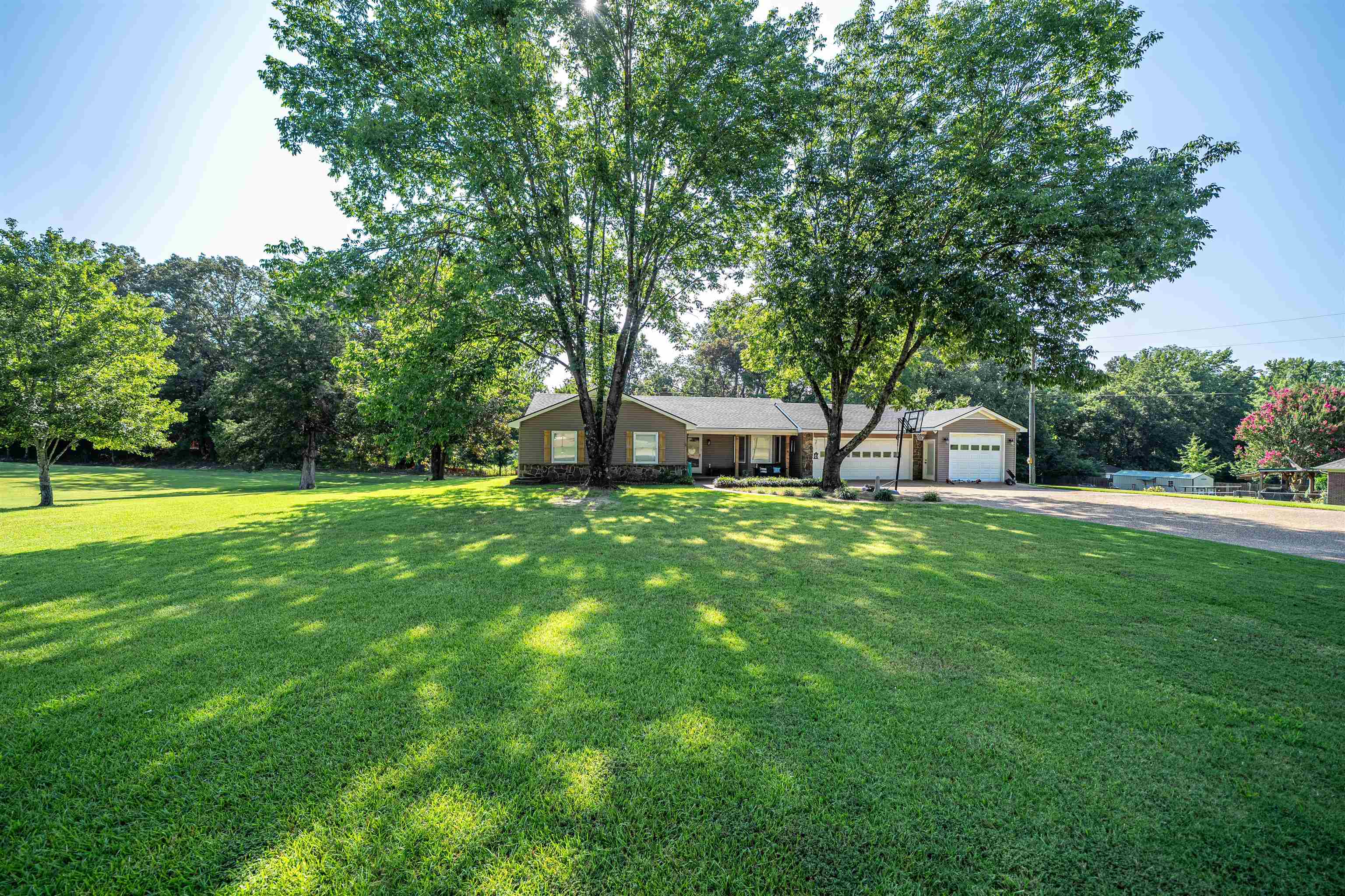 285 Woodbridge Road Somerville, TN 38068 - Photo 19 of 24 a front view of a house with garden and a tree