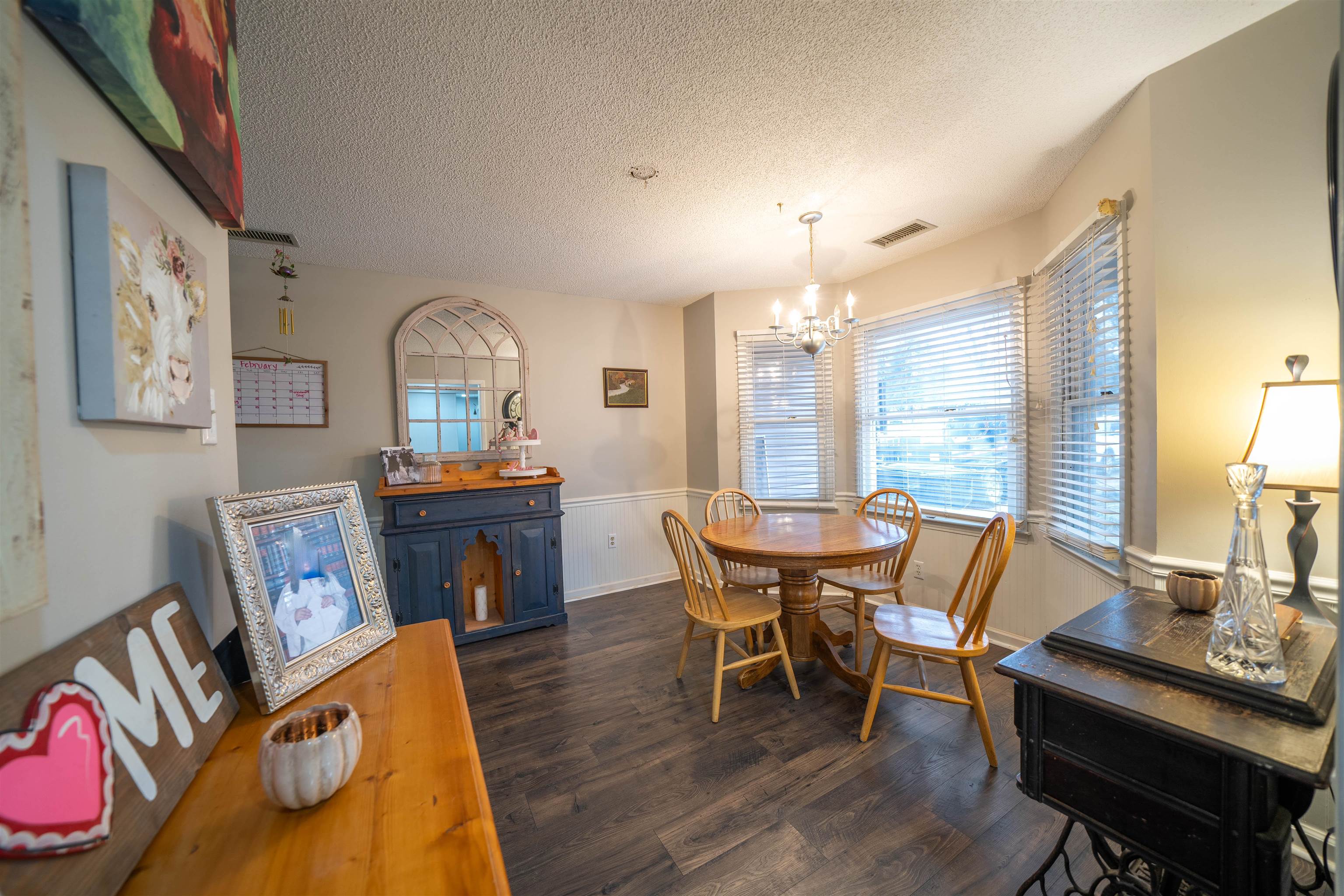 285 Woodbridge Road Somerville, TN 38068 - Photo 4 of 24 a view of a dining room with furniture a chandelier and wooden floor
