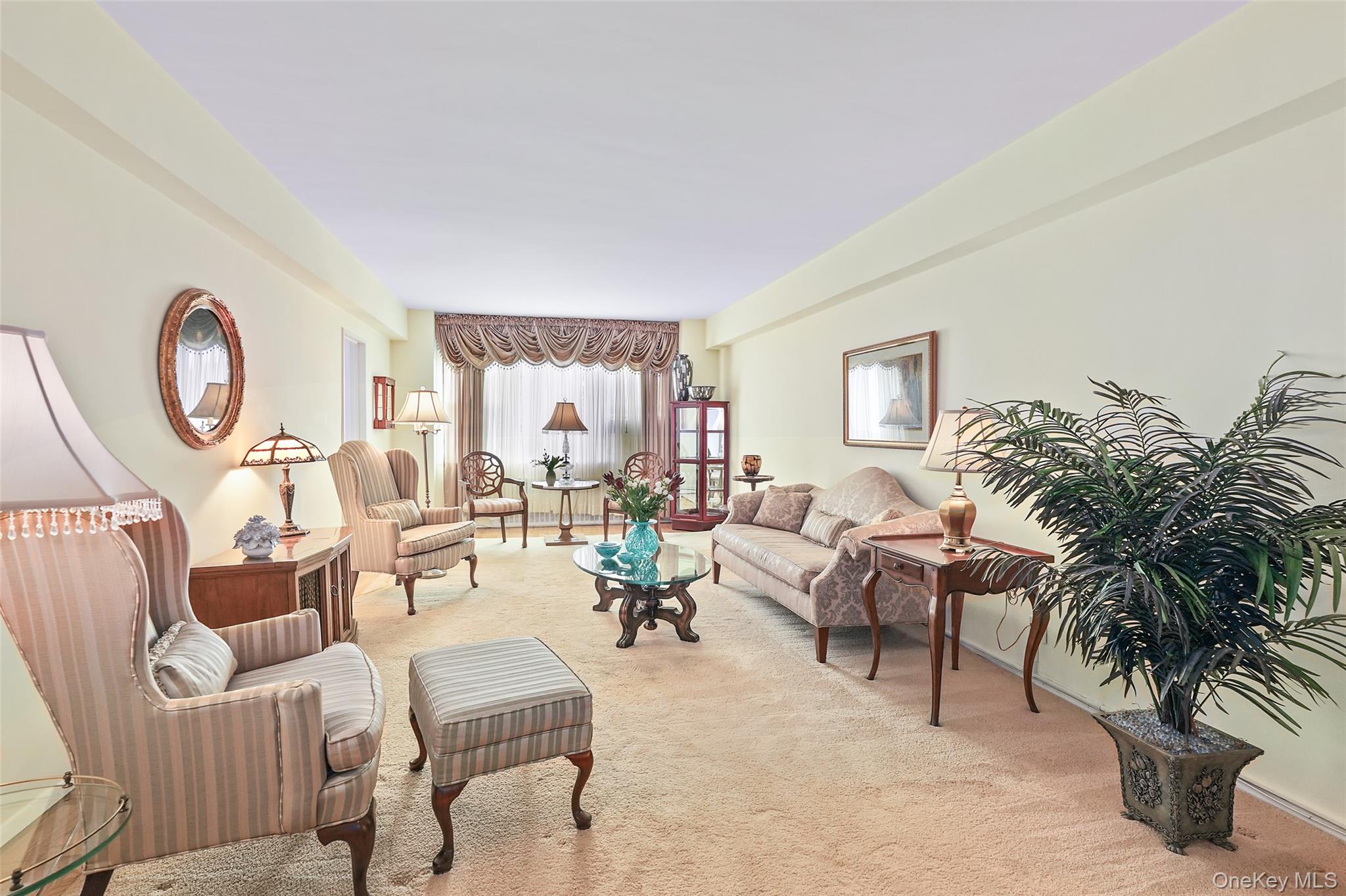 900 Palmer Road, Unit 5A Bronxville, NY 10708 - Photo 1 of 15 a living room with furniture a large window and a potted plant