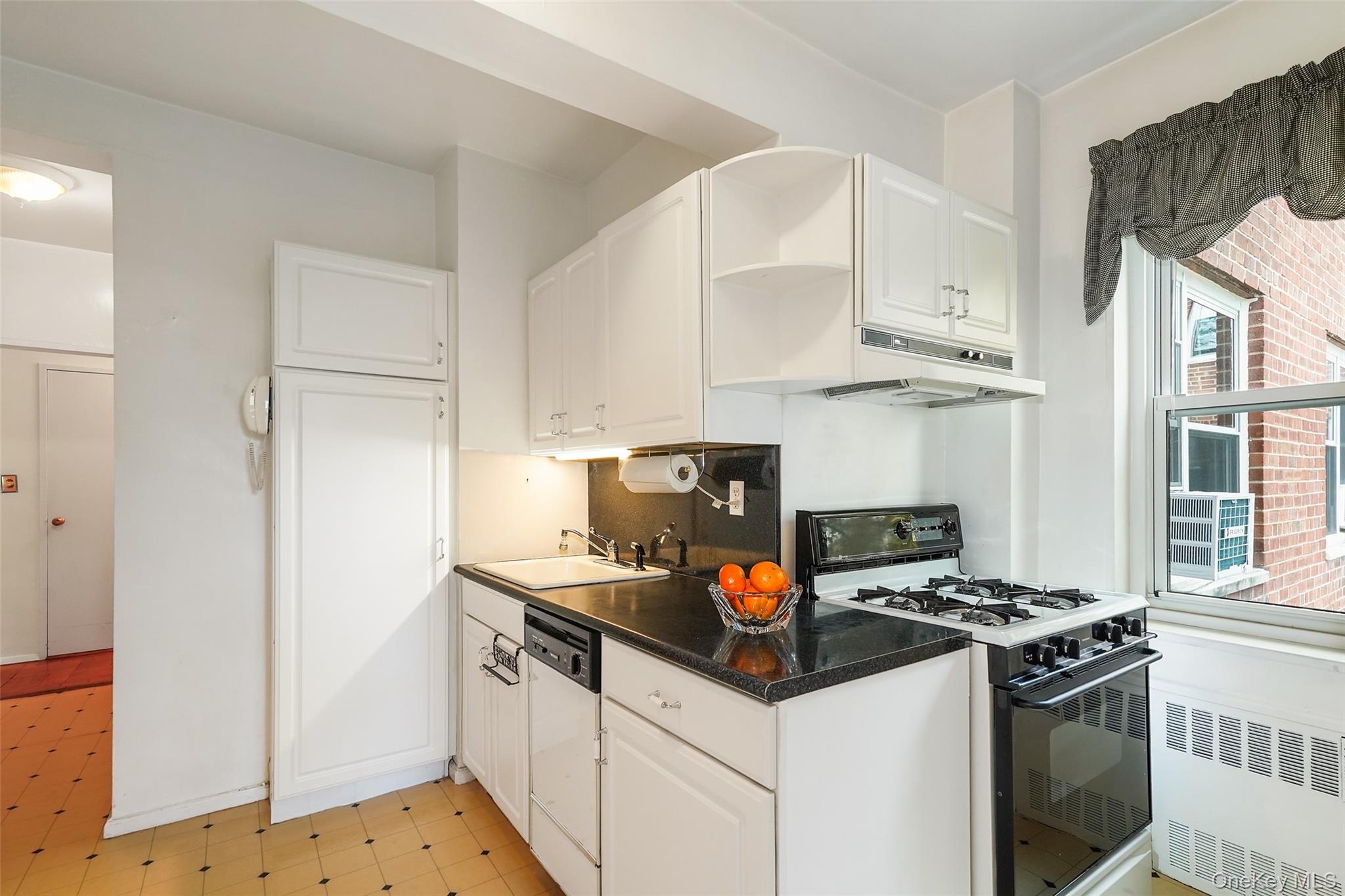 900 Palmer Road, Unit 5A Bronxville, NY 10708 - Photo 5 of 15 a kitchen with stainless steel appliances granite countertop a sink stove and refrigerator