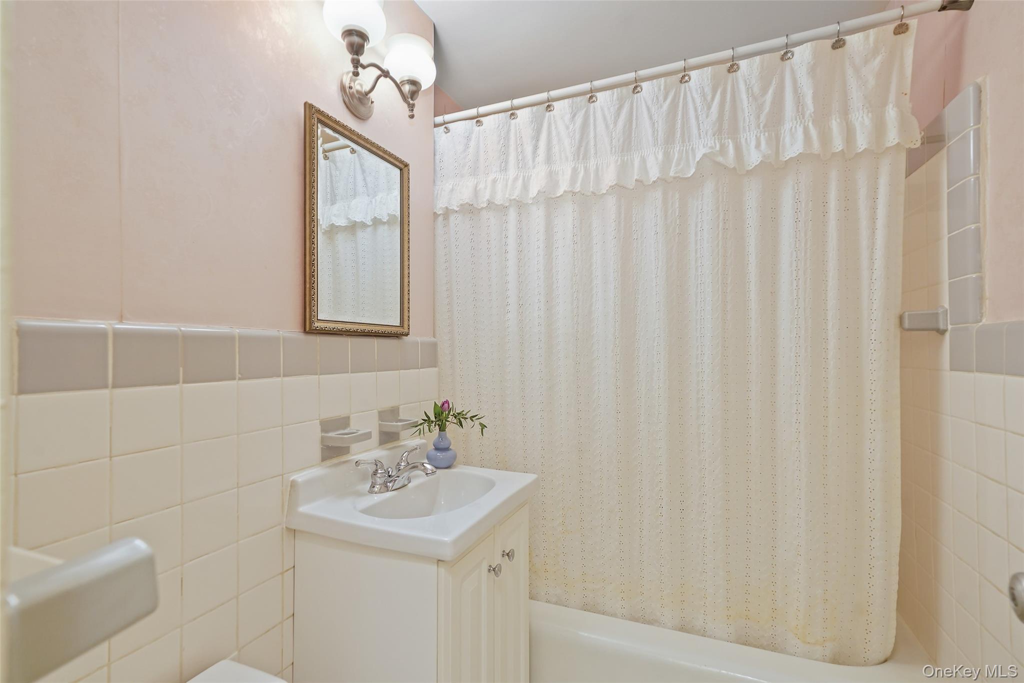 900 Palmer Road, Unit 5A Bronxville, NY 10708 - Photo 6 of 15 a bathroom with a sink a mirror and a shower curtain