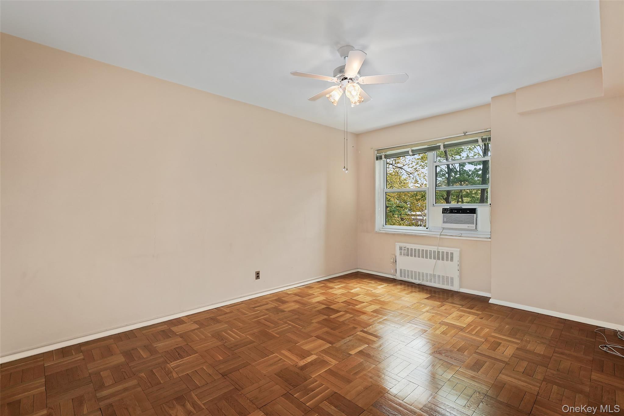 900 Palmer Road, Unit 5A Bronxville, NY 10708 - Photo 7 of 15 a view of an empty room with chandelier fan and fire place