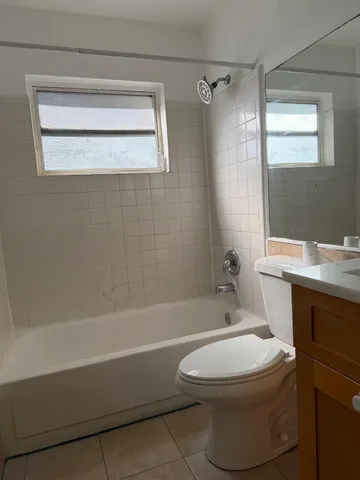 a bathroom with a toilet and a bathtub