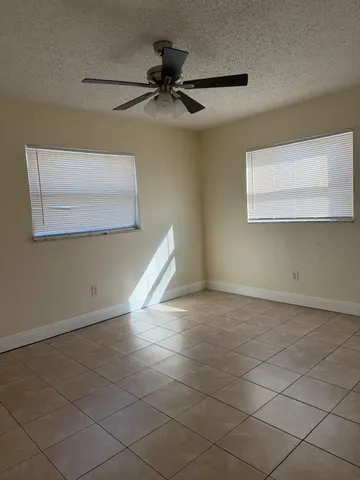 a view of a livingroom with a ceiling fan and window