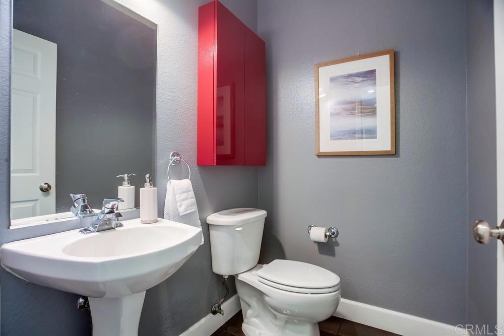 6094 Citracado Circle Carlsbad, CA 92009 - Photo 18 of 47 a bathroom with a toilet a sink and a mirror